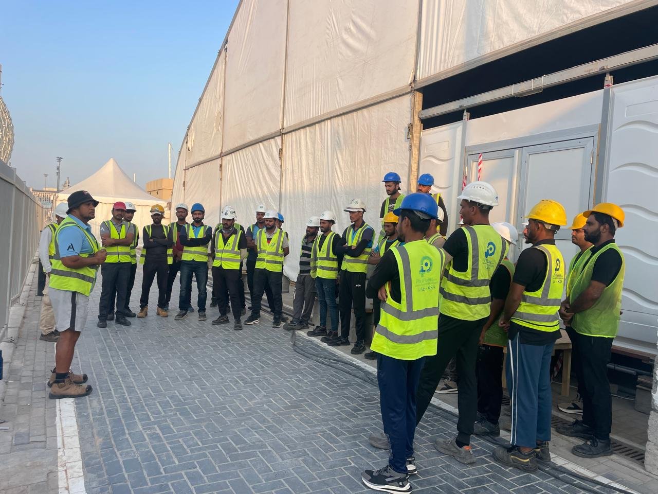 Toko ground crew in hi-vis vests and hard hats at a site briefing